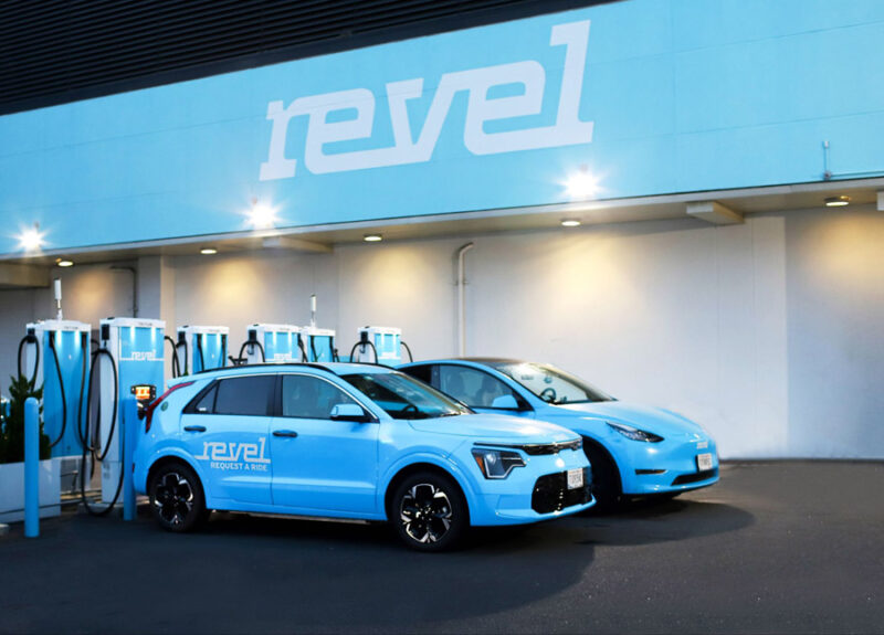 Kia Niro and Tesla Model Y charging at a Revel Superhub.