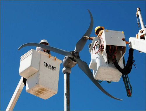 photo of a wind turbine being serviced